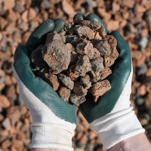 Hands with gardening gloves on holding Rock Mulch